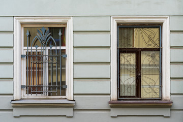two windows behind bars in an old house