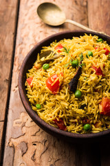 Tomato  pulav/Pilaf made using basmati rice, served in a bowl. selective focus