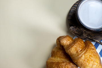 croissant and hot milk on a yellow background, top view,breakfast