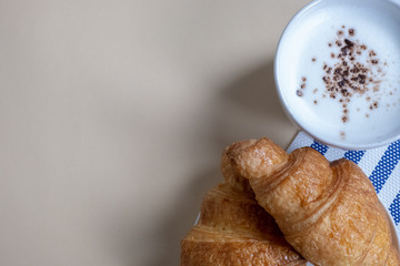 croissant and hot milk on a yellow background, top view,breakfast
