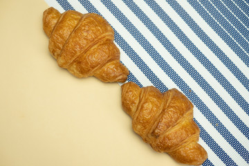 croissant on a yellow background, top view,breakfast