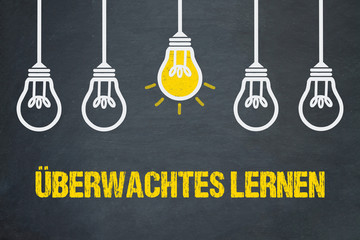 Überwachtes Lernen / Tafel mit Glühbirnen