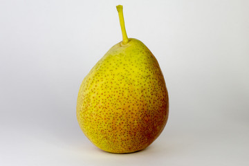 green-red pear on white background, close-up, copy space