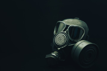 Gas mask on a black table and dark background.