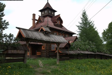 view of the log house and the gate in the village