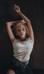 Seductive sexy stylish blonde girl posing on black background. Stylish urban trendy woman model on city street