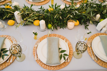 Coziness and style. Modern event design. Table setting at wedding reception. Floral compositions...