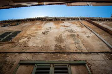 low angle view of an old  house facade with blue sky in the background on a sunny day on Mallorca, Spain