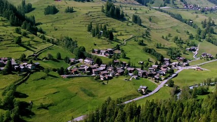 Aerial orbiting view of a typical village of the region of Aosta valley in the Italian Alps