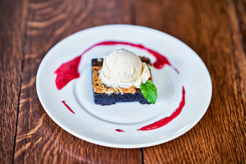 Brownie Sundae with a Scoop of Vanilla Ice Cream and Berry Sauce