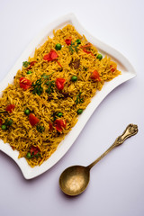 Tomato  pulav/Pilaf made using basmati rice, served in a bowl. selective focus