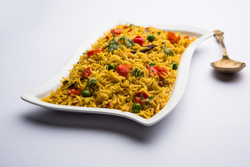 Tomato  pulav/Pilaf made using basmati rice, served in a bowl. selective focus