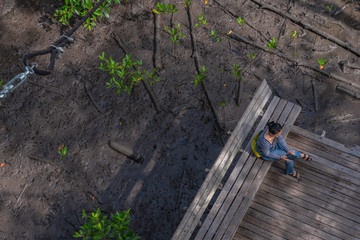 lady sitting on balcony in mangrove forest viewpoint