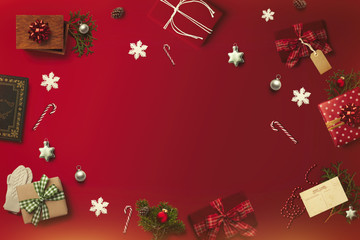 Merry Christmas layout on the red background. Gifts, presents, postcard, canes, snowflakes, cones, pine branches flatlay top view