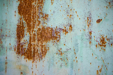 Old corroded metal wall background with flaky blue green paint .Rusty flaky cracked metal surface.Abstract the surface texture of the old metal.