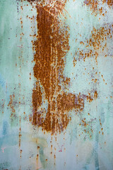 Old corroded metal wall background with flaky blue green paint .Rusty flaky cracked metal surface.Abstract the surface texture of the old metal.