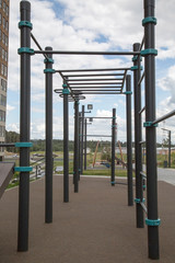 Fototapeta na wymiar Power trainer for hand muscles from the rungs of the tracks on the Playground in the city outdoors. Sport is a healthy lifestyle Hobby.
