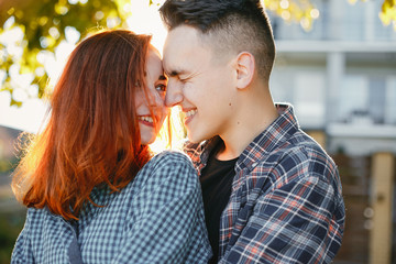 Cute couple in a park. Lady with red hair.