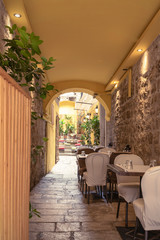 Courtyard in the old town of Split with restaurant, Croatia. Selective focus.
