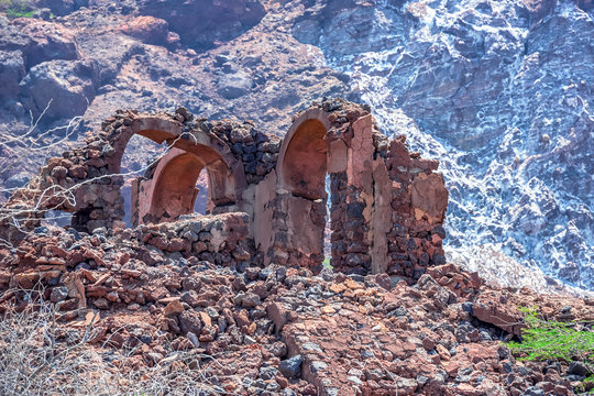 ancient ruined building of the Portuguese colonization era against the background of salt rock on the island of Hormuz, Hormozgan Province, Iran. looks like the Dead Sea coast