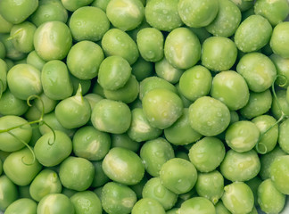 scattered wet green peas close-up