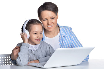 Portrait of emotional mother and daughter using laptop