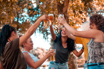 Happy group of best female friends drinking beer - Friendship concept with young female friends...