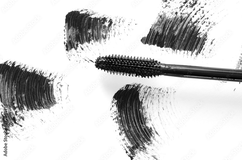 Wall mural Stroke of black mascara with applicator brush close-up, isolated on white background. - Image