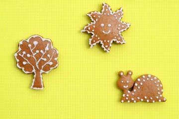 Creative composition with gingerbreads on bright yellow background