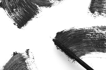 Stroke of black mascara with applicator brush close-up, isolated on white background. - Image