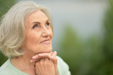 Portrait of happy senior beautiful woman in spring park