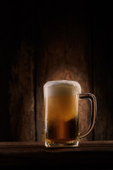 Beer in mug on wooden table