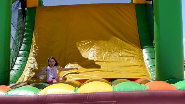 beautiful girl playing in an inflatable castle