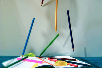 Pencils fall on an open notebook. Back to School Concept.