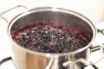 Close-up view of boiling blueberries. Cooking blueberry jam.