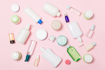 Group of plastic bodycare bottle Flat lay composition with cosmetic products on pink background empty space for you design. Set of White Cosmetic containers, top view with copy space
