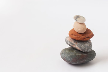 Fototapeta na wymiar zen symbol, relaxing colorful stones with white background