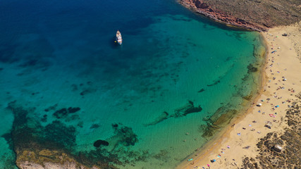 Aerial drone bird's eye view photo of iconic turquoise clear water sandy beach of Agios Sostis in island of Mykonos, Cyclades, Greece - obrazy, fototapety, plakaty