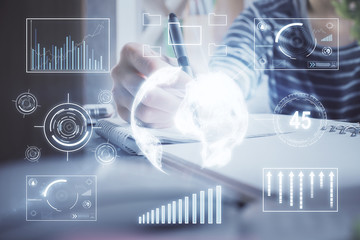 Financial forex graph drawn over hands taking notes background. Concept of research. Double exposure