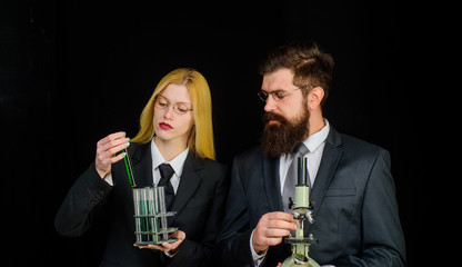 Science, chemistry, biology, technology and people concept. Scientists with test tube and microscope. Research in clinical laboratory. Lab experiment. Modern education. Microscope and testtubes. STEM.