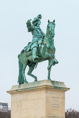 Fototapeta premium Equestrian statue of Louis XIV on Place d'Armes in front of Palace of Versailles. Palace Versailles was a royal chateau.