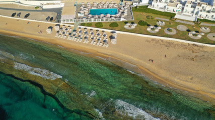 Fototapeta premium Aerial photo of famous sandy beach with turquoise clear sea of Megali Amos next to iconic and picturesque main town of Mykonos island, Cyclades, Greece