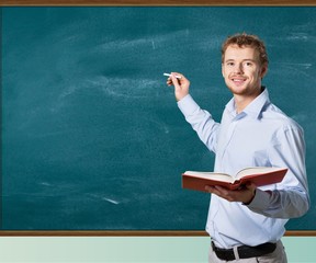 Young male teacher   standing with book