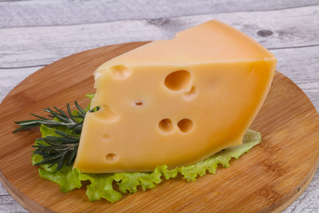 Maasdam cheese  in the board served salad leaves