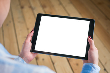 Mockup image: over shoulder close up view of woman looking at modern digital tablet computer device with white blank screen. Mock up, copyspace, leisure time, template and technology concept
