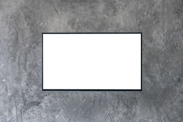 Mock up, copyspace, template, entertainment and technology concept - black flat smart led TV mockup with white blank screen hanging on grey grunge wall