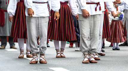 estonian people in traditional clothing walking the streets of Tallinn