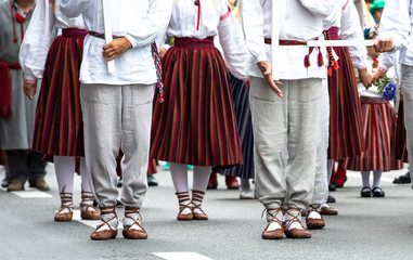 estonian people in traditional clothing walking the streets of Tallinn