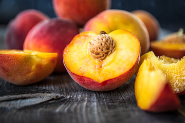 Fototapeta na wymiar Fresh organic peaches on old wooden table