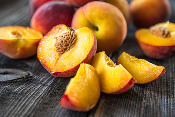 Fresh organic peaches on old wooden table